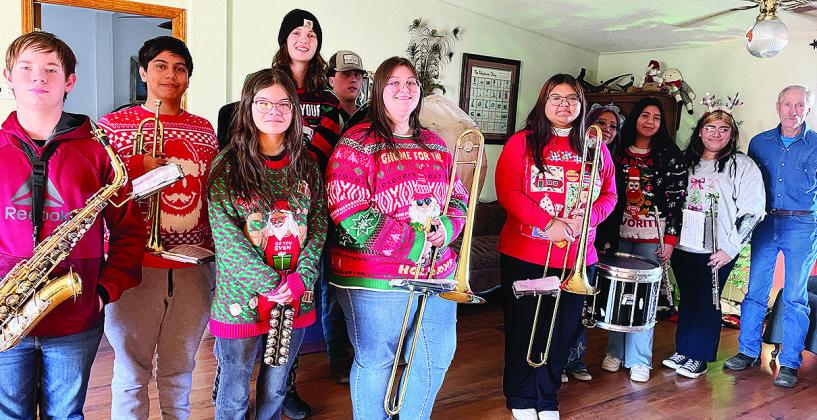 CHS band members playing songs included, from left, Charles Terrell, Jesus Bonilla, Hazel Hoffman, Jackson McCullough, Corbin Weaver, Abigail Williams, Belicia Gamon, Jules Harrison, Karely Aguilar Guzman, Ashley Garcia and homeowner Mike Mapel. Not pictu