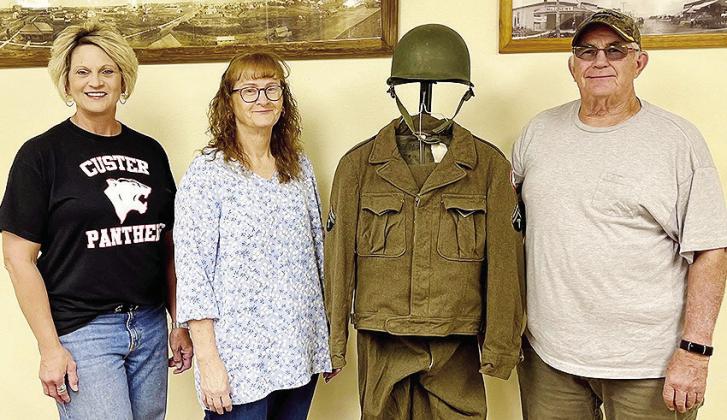 From left, Dian Carpenter, Patsie Miller Guy, and Wade Reichert stand with the World War II uniform of Patsie’s father, James “Jack” Miller of Custer City. CDN | Courtesy photo