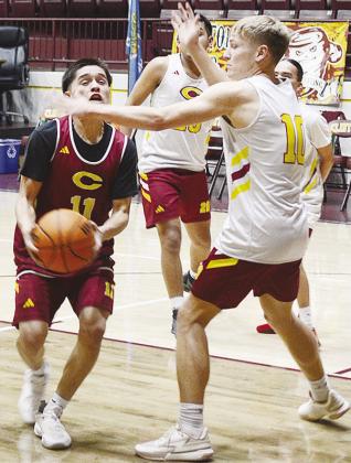 Clinton’s AJ Reynolds, left, fights through teammate Parker Adams on his way to the basket during practice in the Tornado Dome. CDN | Sam Goodwyn