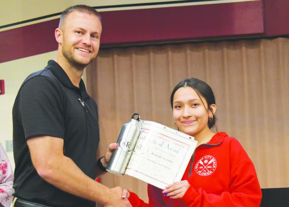 WTC Director of Student Services Zane Trammell, left, presents the Outstanding Studebt of the Year Award to welding student Aaliyah Torres of Clinton High School.