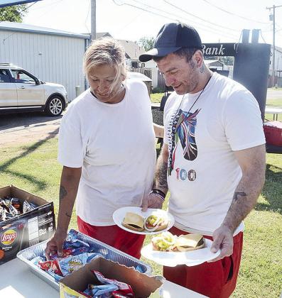 Lisa Vinson, left, and her husband James pick out some side snacks during the cookout.