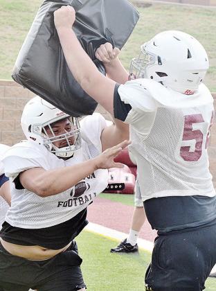 Clinton’s Alex Amaya, left, blocks Kolton Fuller during an Oline drill to start practice Monday in the Tornado Bowl. CDN | Sam Goodwyn