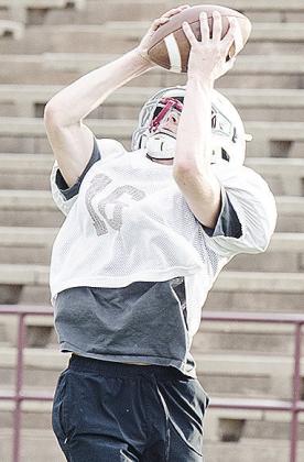 Rielon Woodford goes up to catch the ball during practice Monday. CDN | Sam Goodwyn