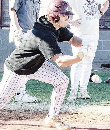 Clinton’s Vince Jones lays down a bunt during practice at the baseball field. CDN | Sam Goodwyn