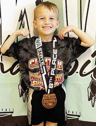 Kyson Lovelace flexs his muscles after coming in eighth in the 37-pound class of the 8U bracket of the OKWA Wrestling Tournament in Oklahoma City. CDN |Courtesy Photo