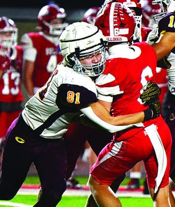 Clinton’s Ben Daugherty takes down Cache’s quarterback during the Red Tornadoes’ road game Thursday against the Bulldogs. CDN | Micah Ashcraft