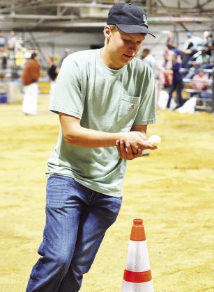 Clinton’s Ben Christie focuses on his egg during the Custer County Free Fair Farmhand Olympics egg race. CDN | Micah Ashcraft