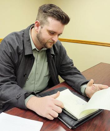 Detective Paul Sperle looks over notes for a case before starting his day at the Clinton Police Department. CDN | Shiann Dawson