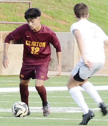 Clinton’s Austin Reynaga, left, tries to get the ball around the Chickasha defender during the Red Tornadoes’ first round playoff win over the Fighting Chicks Monday at home. CDN | Sam Goodwyn