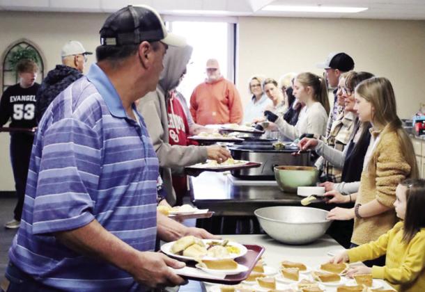 Members of the community receive a Thanksgiving meal from volunteers at the annual Cornerstone Church Thanksgiving Feed.
