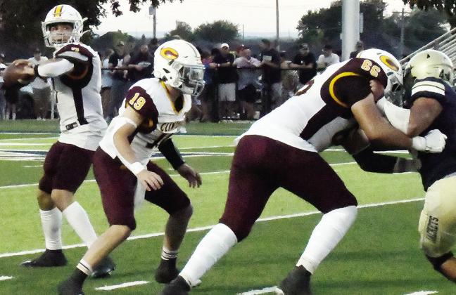Clinton’s Easten Powell prepares to throw the ball while, No. 19 Dyson Moss comes to assist No. 66 Andre Lime with blocking a Kingfisher defender during the Red Tornadoes’ road game Friday against the Yellowjackets. CDN | John Kinsey