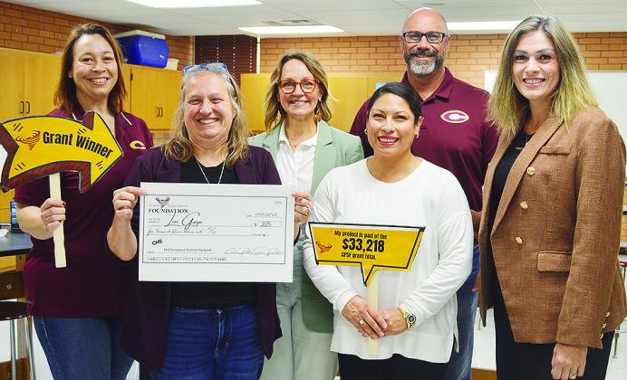 From left, Clinton Public Schools Asst. Supt. Melissa Knabe, Dr. Lori Gwyn, Clinton Public School Foundation Board Member Jenn Mosburg, Board Member Arleth Cifuentes, Supt. Nathan Meget, and Clinton High School Principal Michelle Sorter present Gwyn with 