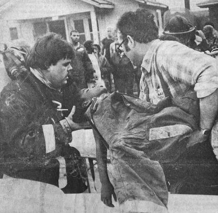 40 YEARS AGO Smoke inhalation victim Angel Ford, 7, was loaded on an ambulance cot by Clinton firefighter Robert McDown, left, and Capt. Leon Kinder after being removed from a burning house at 201 E. Terrace. Firefighters revived the child, who was transp