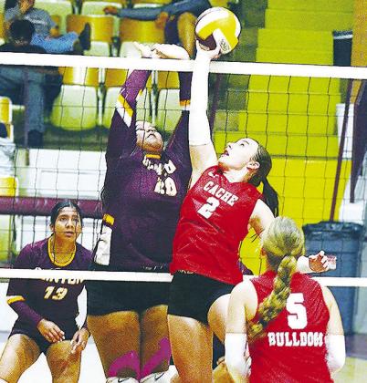 Clinton’s Aracelie Chavez goes up to meet the Cache player in an attempt to block her, while Karely Aguilar looks on during the Lady Reds’ match against the Lady Bulldogs Thursday in the Tornado Dome. CDN | Sam Goodwyn