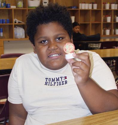 Ian Aguilar shows off his ping pong light made during the Discovery Zone class taught by JoDee Adney Wednesday at Washington Elementary. CDN | Christian Jacobsen
