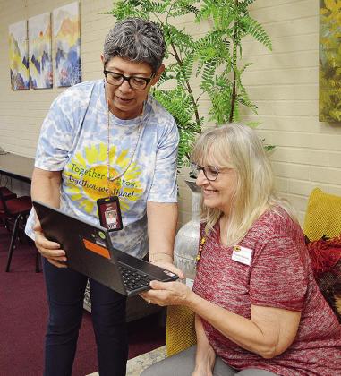 Juanita Carrizales, left, and Connie Hileman check a student’s information on a school Chromebook at the Southwest Elementary School front office. CDN | Micah Ashcraft