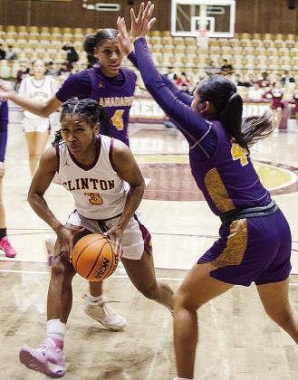 Clinton’s Arlena Kirkendoll, left, forges through two Anadarko defenders as she fights her way through the lane during the Lady Reds’ home game against the Lady Warriors. CDN | Sam Goodwyn