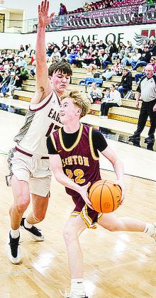 No. 21 Axl Deatherage drives against a defender as he heads toward the basket during Clinton’s playoff game Saturday in Weatherford. CDN | Sam Goodwyn