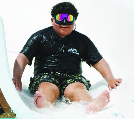 Fabian Rodriguez slides into the pool with goggles attached. CDN | Christian Jacobsen