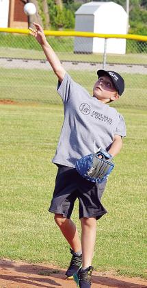 Oliver Hammans watches the ball as he throws it back to a coach during a T-Ball game. CDN |Sam Goodwyn