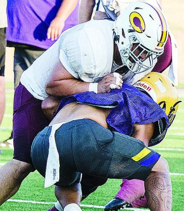 Clinton’s Alex Amaya attempts to flatten the Anadarko defender as he blocks him during the Red Tornadoes’ scrimmage against the Warriors in the Tornado Bowl. CDN | Sam Goodwyn