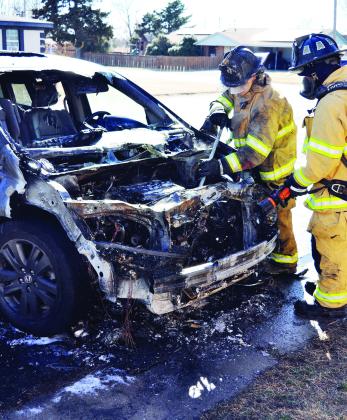 Clinton Firefighters Bobby Winans and Alex Tyler make sure this torched van does not reignite Monday afternoon in the 1600 block of Dunn Avenue. CDN | Staff Photo