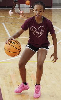 Teriana King goes through a dribbling drill during a basketball camp in the practice gym at the high school. CDN |Sam Goodwyn