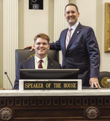 Preston Payne, left, sits at the chair of the Speaker of the House with Speaker Pro Tempore Anthony Moore after returning to page. CDN | Courtesy photo