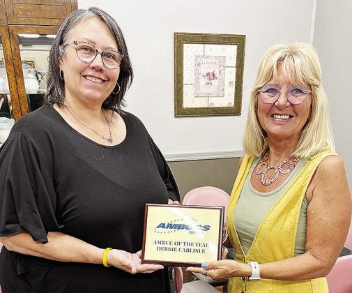 Misty Crider, left, presents Debbie Carlisle with a plaque after she was recognized for the AMBUC of the Year Award. CDN | Courtesy photo