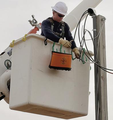 Stetson Ryan adjusts a string of wires while making repairs to a utility pole just off the intersection at Lexington Avenue and Gary Boulevard. CDN | Staff Photo