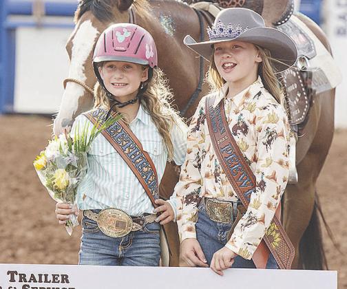 Emma Shannon, left, is presented a check for winning the Sweetheart title in the Rodeo Royalty pageant from last year’s winner Emma Townsley.