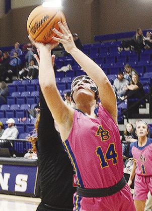 No. 14 Peyton Lambeth fights through a Calumet defender as she goes up for a layup in A-B’s win over the Lady Chieftans. CDN | Sam Goodwyn