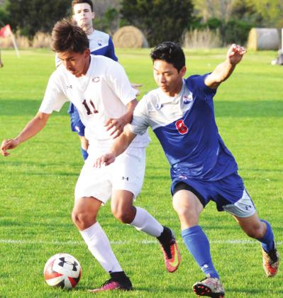 Clinton senior midfielder Roberto Solis fights to keep possession of the ball against Christian Heritage. CDN | Collin Wieder