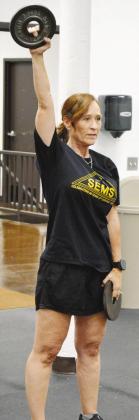 Anne Lambeth trains her arm strength at the Acme Brick Park weight room. CDN | Christian Jacobsen