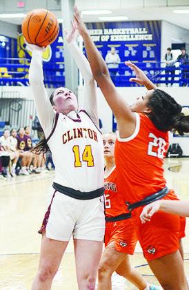 Clinton’s Brooklyn Aston attempts a layup against a Cushing defender in the Lady Reds’ playoff game against the Lady Tigers. CDN | Sam Goodwyn
