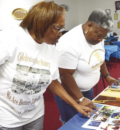 Bonnie Fisher Randle, left, and Susanna Williams go over the posters for the Excelsior School reunion parade set to start at 9 a.m. Aug. 2. CDN | Courtesy photo