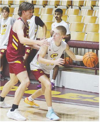 Clinton’s Ayden Crumley, left, guards Ryder Adams during a recent Reds’ basketball practice in the Tornado Dome. CDN |Sam Goodwyn