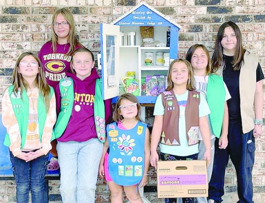 From left, Kendra Jones, Serenity Musick, Paislee Hawthorne, Addison Humphreys, Kennedy Humphreys, Preslie Hines, and Emorie Hines donate Girl Scout cookies to the blessing box at United Supermarket.