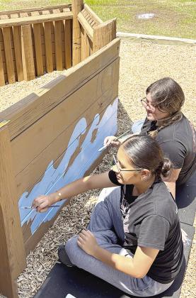 Rochel Mendieta, front, and Nataly Rosales were making waves on the side of the boat feature that was built last fall by volunteers at the M.T. and Helen Gholston Children’s Park. Art students from Joy Badillo’s Clinton High School art class donated t