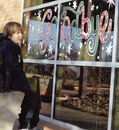 Washington Elementary Student Desmond Oliver reflects on the sign reading “Goodbye Washington” during the final days of classes before moving into the new Clinton Middle School Building starting next semester. CDN | Micah Ashcraft