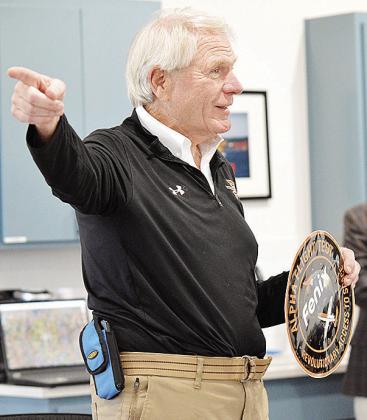 Fenix Space Safety Officer Dan Handlin shows off a decal during a presentation over the company’s concept design testing, which occurred at the Oklahoma Space Port in Burns Flat. CDN | Staff Photo