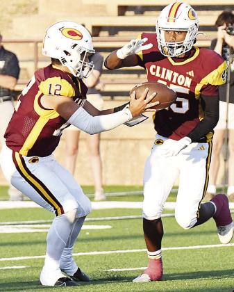 Clinton’s No. 12 Sutton Hernandez hands the ball off to Darrius Hicks during the Red Tornadoes’ home win over Kingfisher. CDN | John Kinsey