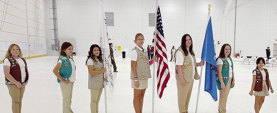 From left, Troop 262 Girl Scouts Lily Martinez, Preslie Hines, Melanie Moy, Kendra Jones, Emorie Hines, Paislee Hines, and Camila Murphy in color guard at the grand opening of the Premium Aerospace Hanger 234 in Burns Flat. CDN | Courtesy photo