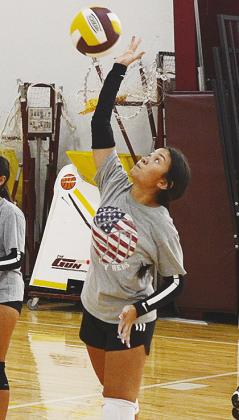 CDN | Sam Goodwyn Lexi Soto keeps her eyes on the ball as she prepares to send it over the net during practice.