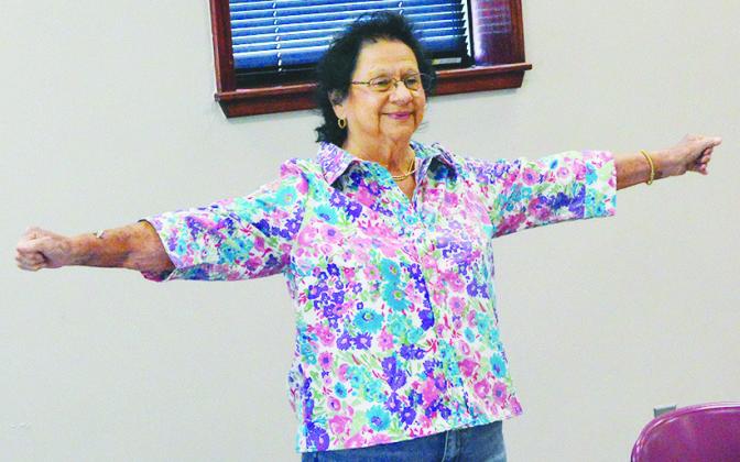 Norma Fisher stretches her arms and trains her muscles during the low-impact workouts at Clinton Regional Hospital. CDN | Christian Jacobsen