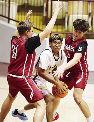 Clinton’s Jose Gamez fights through two Weatherford defenders during the Whirlwinds’ eighth-grade game Monday. CDN |Steve Wheeler