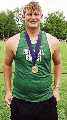 Former Clinton track and field athlete Wyatt Willougby smiles as he shows off his medal from a meet this year with Oklahoma Baptist University. CDN | Courtesy photo