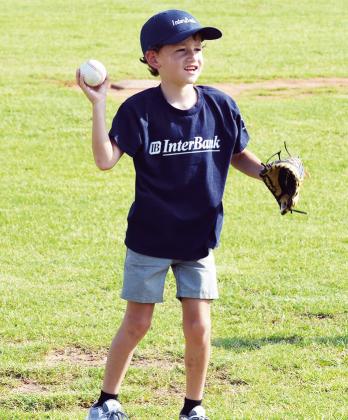 Tad Stovall aims his throw as he prepared to play in his Noon Lions Club T-Ball game at Schumacher Fields at Acme Brick Park. CDN | Sam Goodwyn