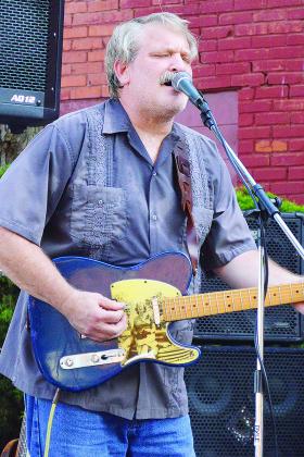 Singer of Elk City band Slim Pickins Chris Gathings entertains the crowd at Friends on Frisco Thursday evening at Engleman Park. CDN | Micah Ashcraft