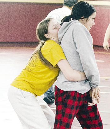 Clinton’s Aryana Pugh, left, grapples with Pricila Gutierrez-Banuelos in an open practice in the wrestling room during winter break. CDN | Sam Goodwyn